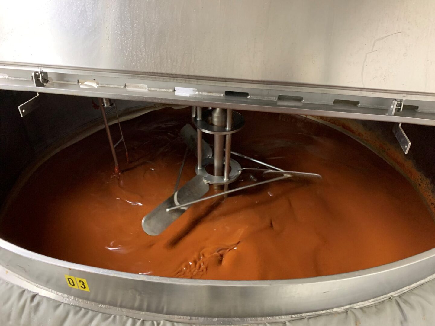 Chocolate liquid being mixed by a machine